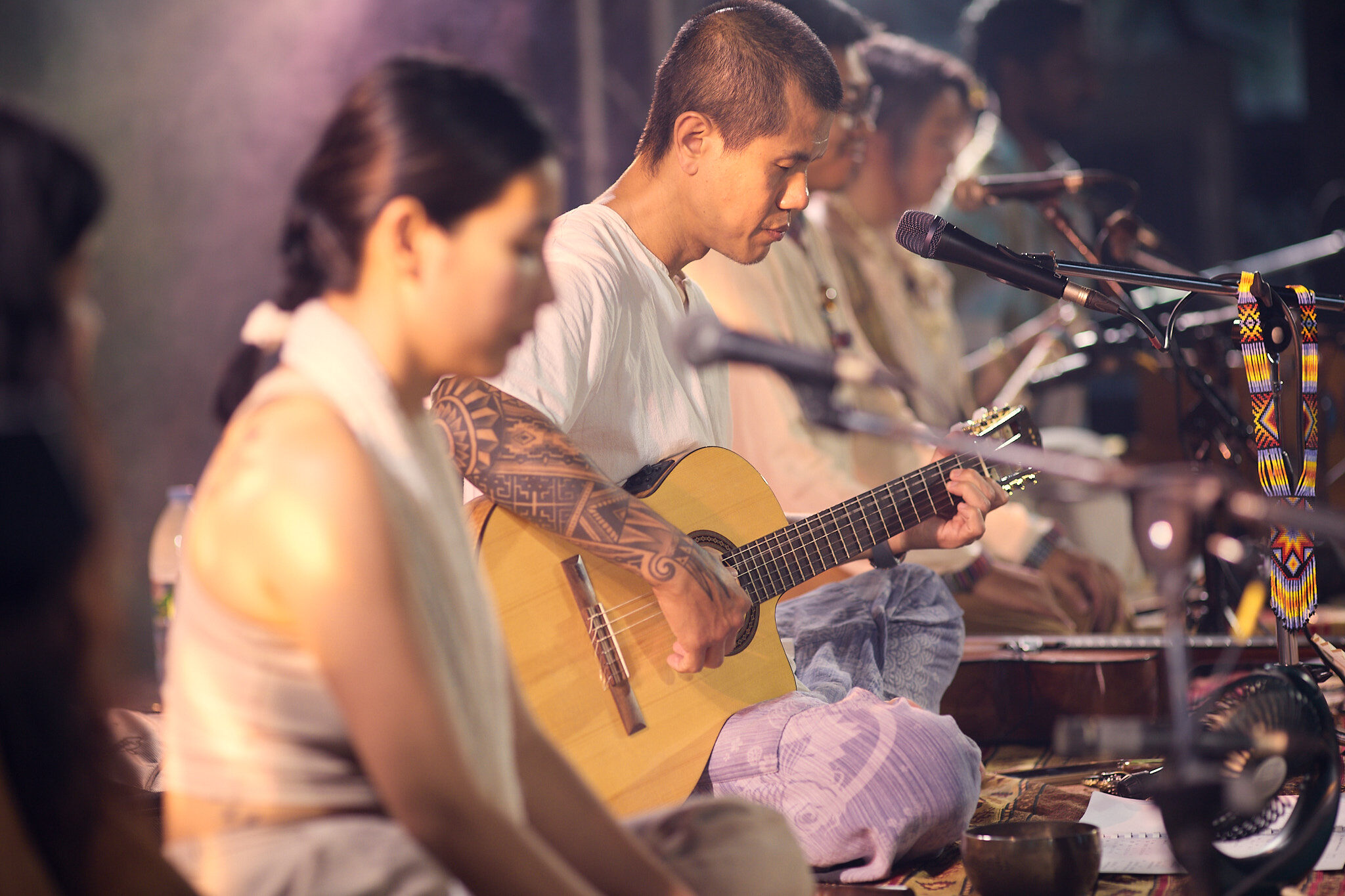 Kay playing guitar in ensemble by candlelight