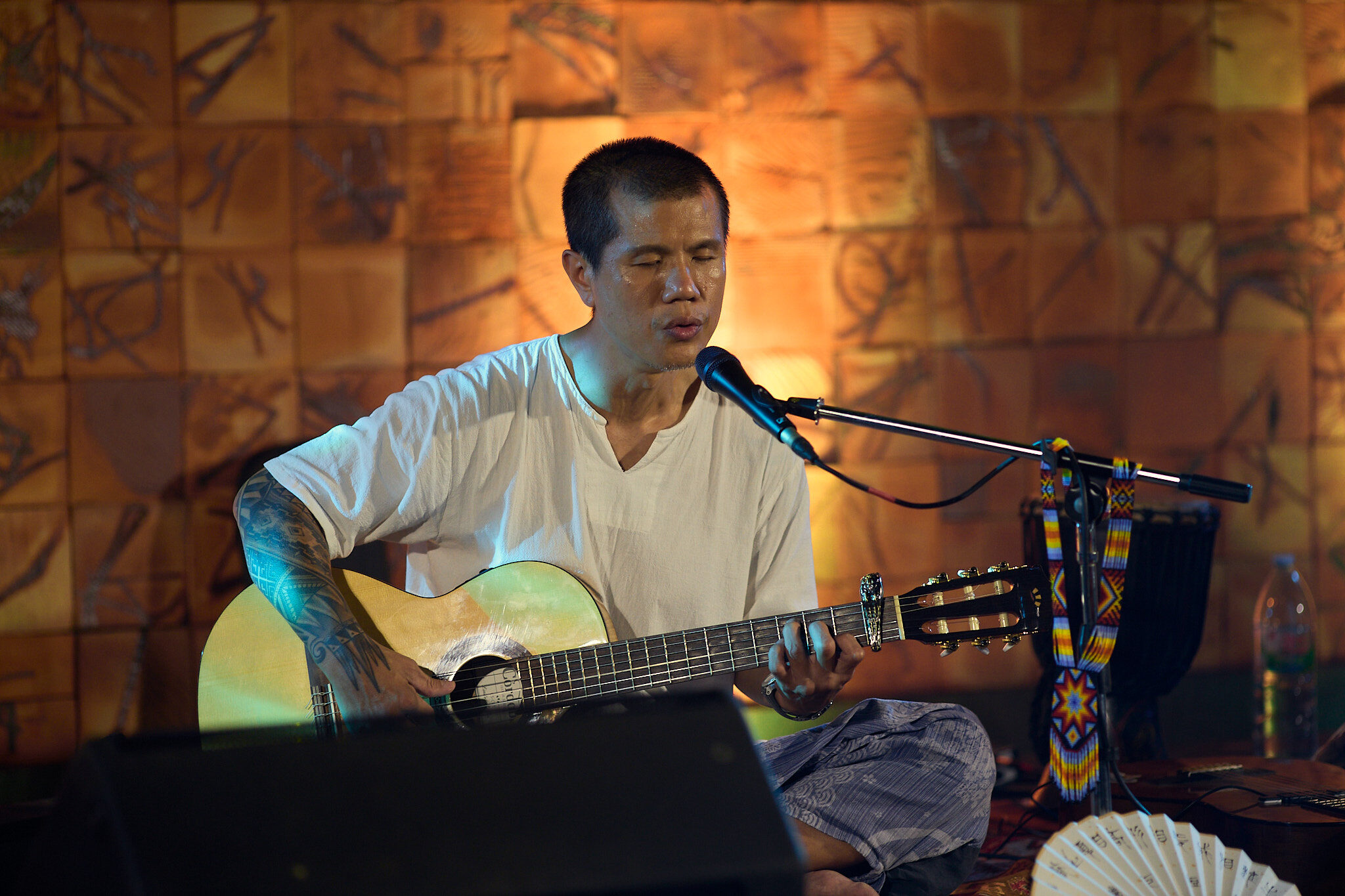 Solo performance against a warm tiled backdrop
