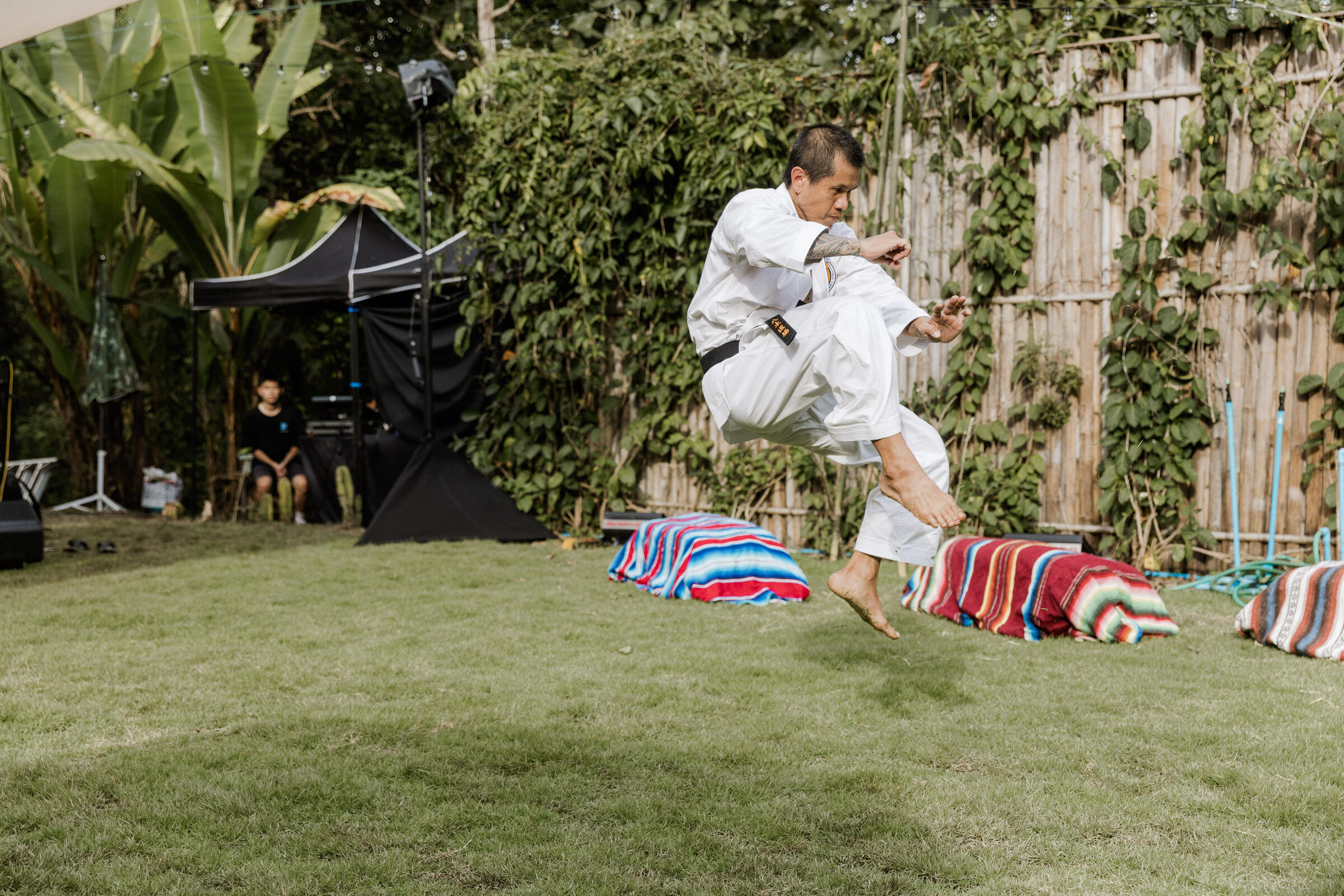 Kay mid-air in a flying kick