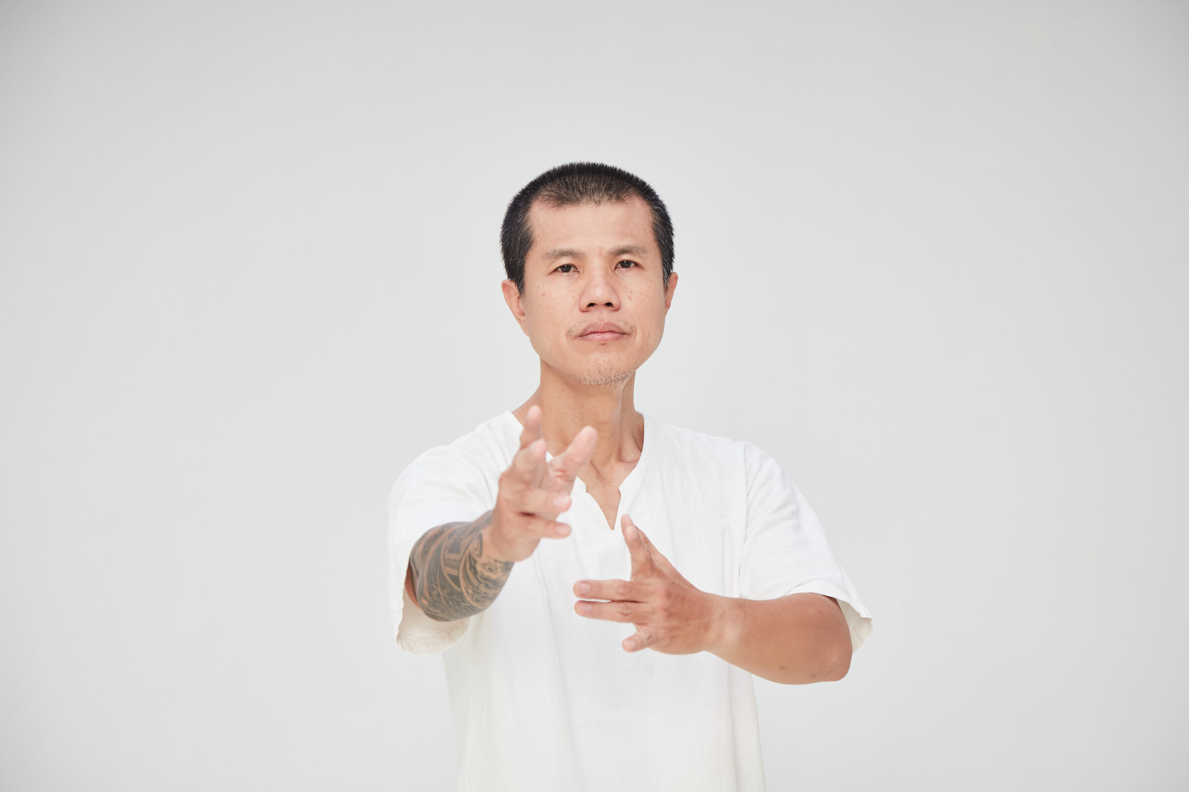 Kay extending an open hand, Taiji form