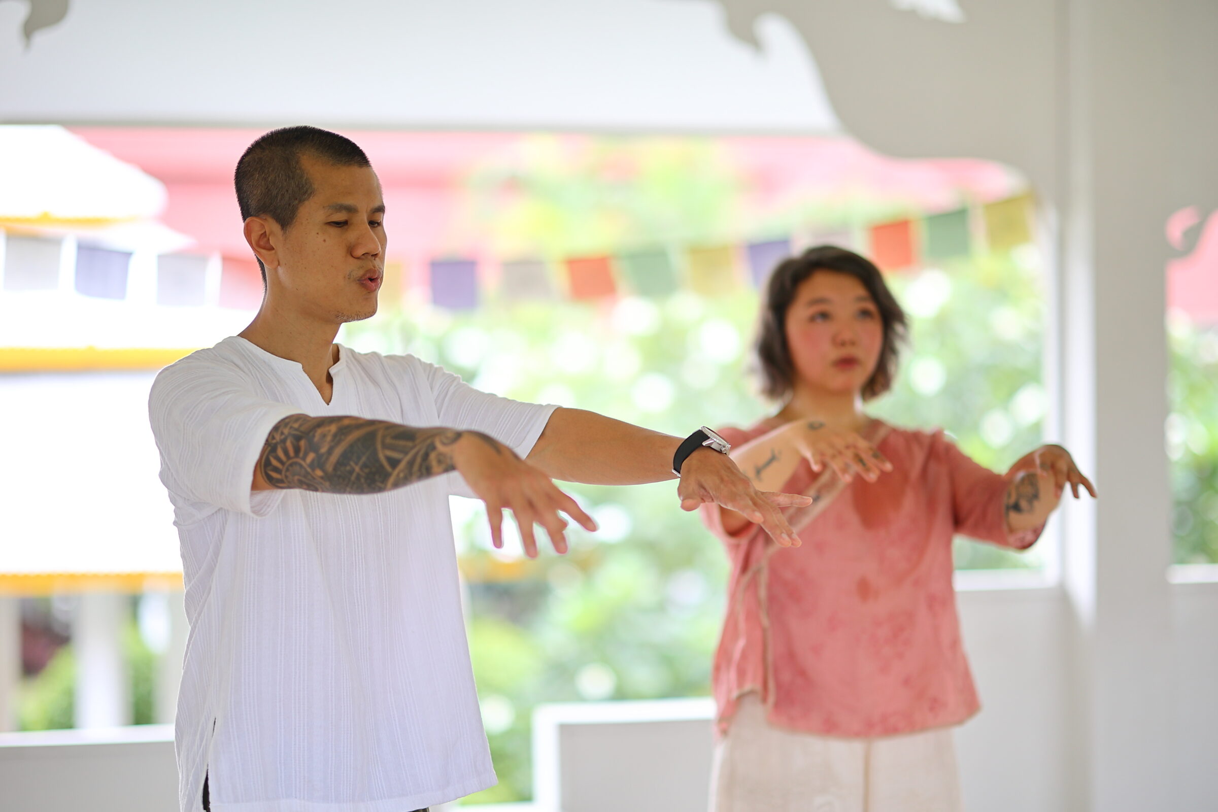 Pair practice at Amaravati with prayer flags
