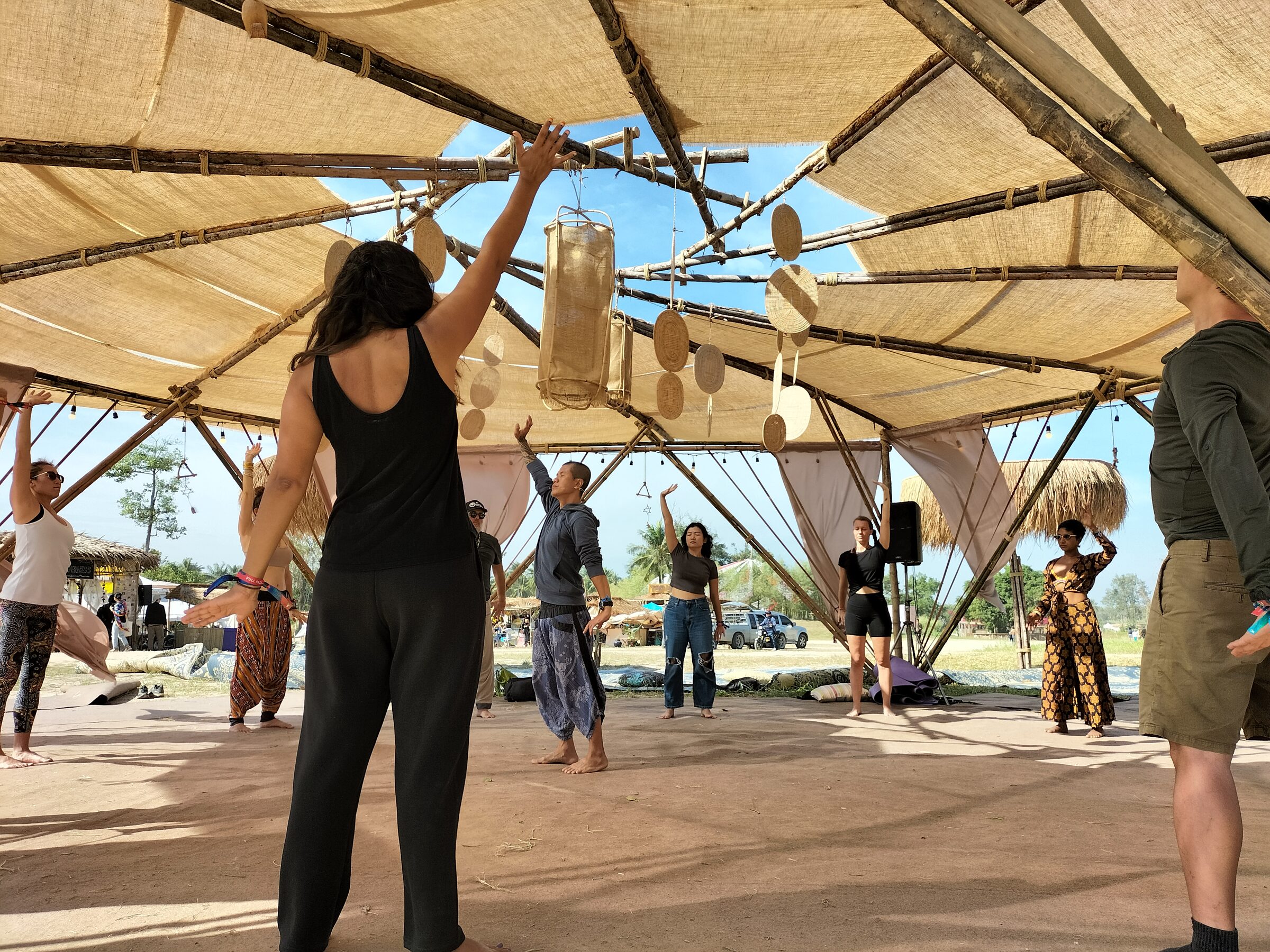 Group Taiji class beneath a bamboo pavilion